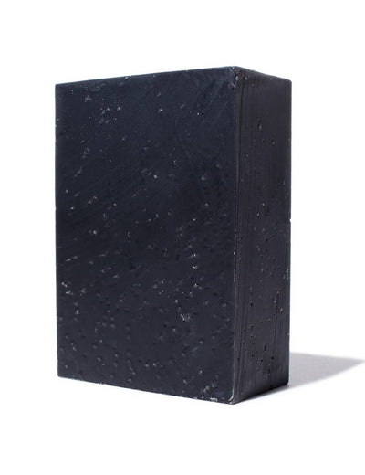 
                    
                      Charcoal Soap Bar, dark gray bar soap with natural speckled texture, angled standing view showing side.
                    
                  