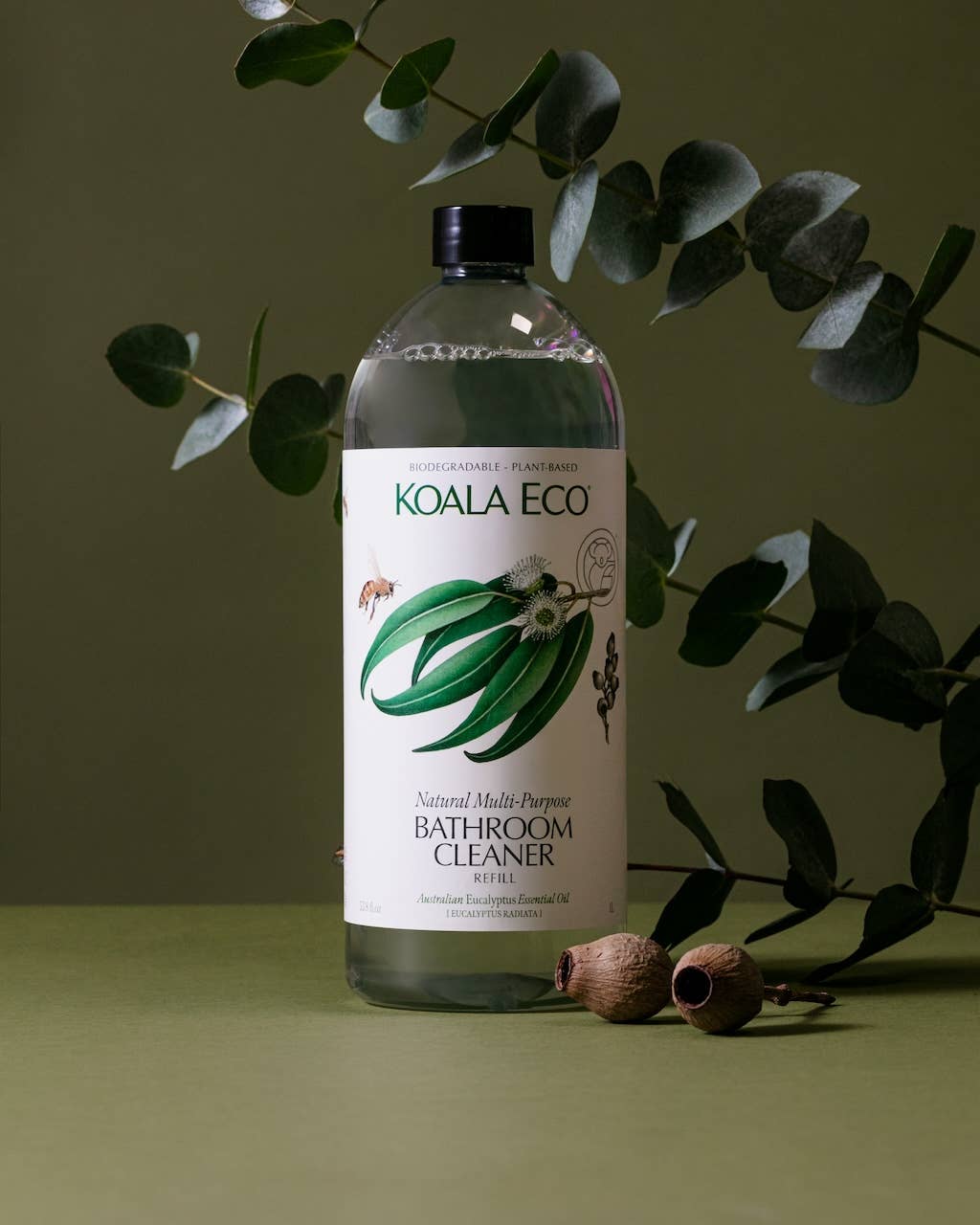 Koala Eco Eucalyptus Multi-Purpose Bathroom Cleaner Refill, clear bottle with black cap, partially filled, surrounded by…