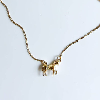 
                    
                      Horse Girl necklace, 14k gold-plated brass horse pendant and gold chain, flat lay detail.
                    
                  