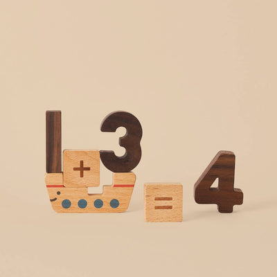 
                    
                      Numbers Play Block Set: walnut 1, 3, 4; beech '+' '=' blocks. Ship block with blue dots forms '1 + 3 = 4'.
                    
                  