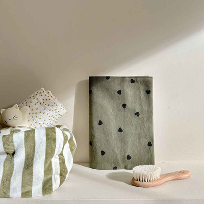 
                    
                      Vic toiletry bag, olive 100% cotton terry fabric with black heart pattern, folded detail view.
                    
                  