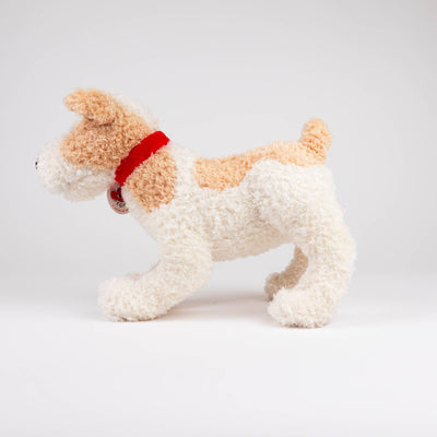 
                    
                      Eliot Plush Stuffed Dog, white and tan with a red fabric collar, standing side profile view.
                    
                  
