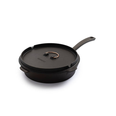 
                    
                      Barebones 12" Cast Iron Skillet, Dutch oven lid with copper loop handle, angled view on white background.
                    
                  