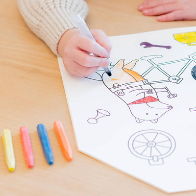 
                    
                      Jumbo House paper coloring book, child's hand coloring a character with a water pen. Colorful chalks on wood table, in-use.
                    
                  
