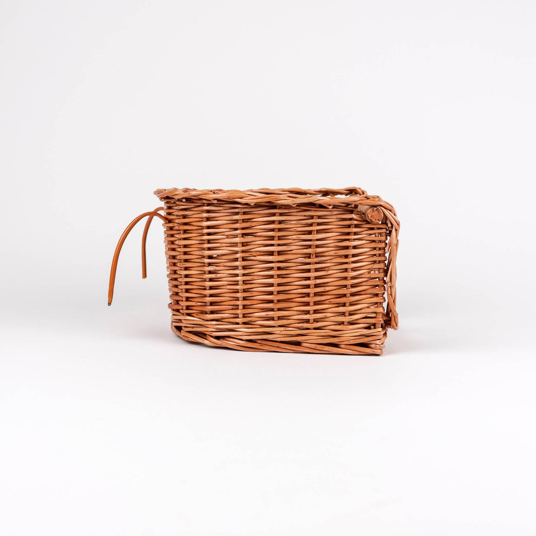 Wicker Bike Seat for Dolls, natural brown woven wicker, side view showing attachment straps on white.