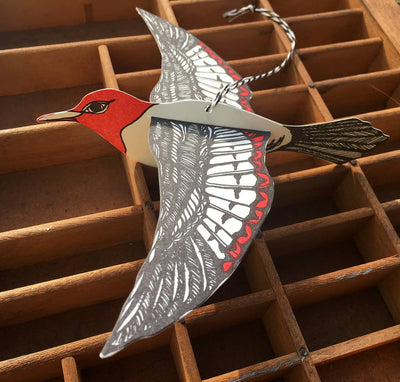 
                    
                      Woodpecker Pop-Out Die-Cut Card, red, black, white cotton paper bird design, hanging by string, dimensional detail view.
                    
                  