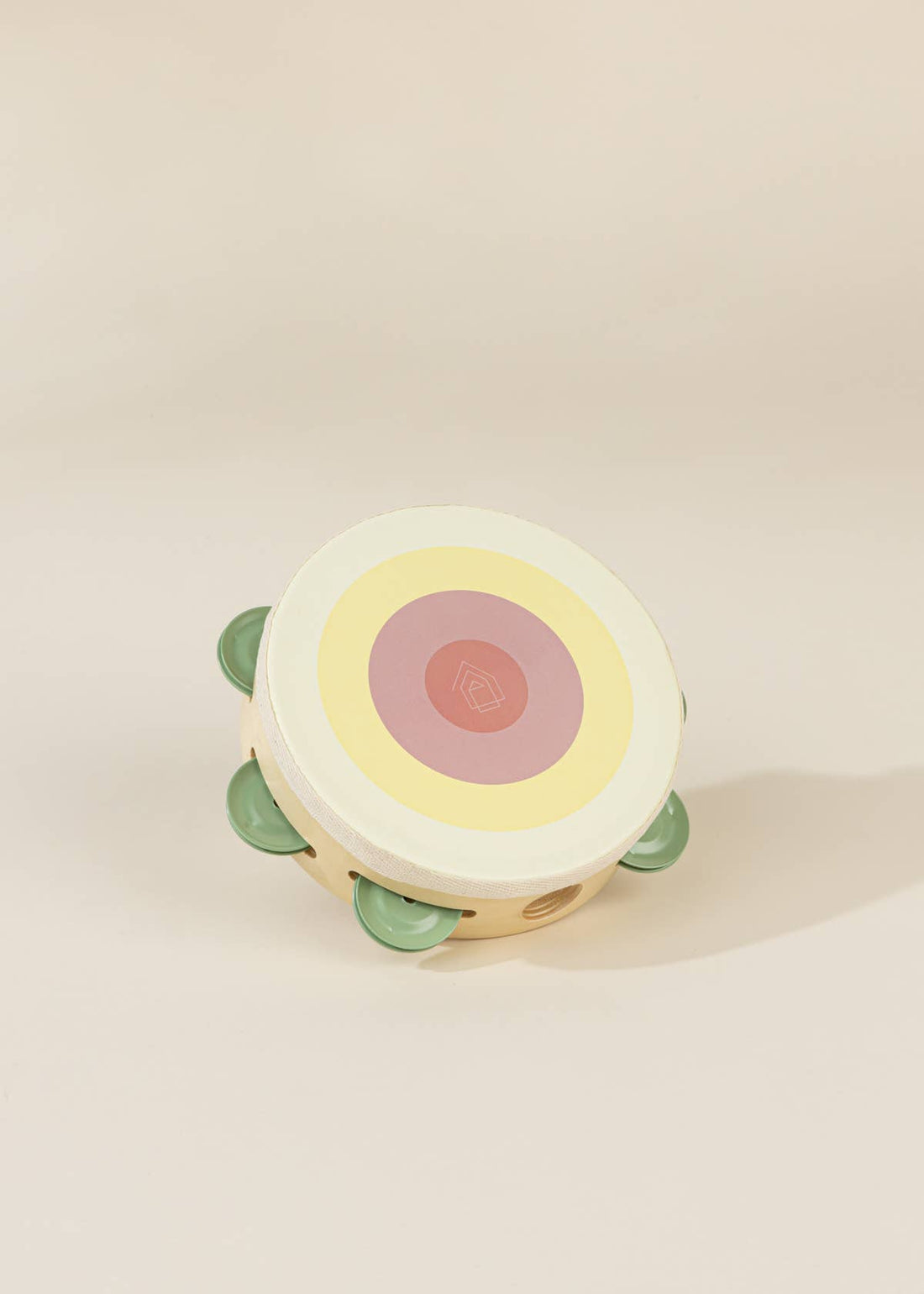 Wooden Musical Instruments Playset tambourine, light wood, pastel concentric circles, sage green jingles, angled close-up…