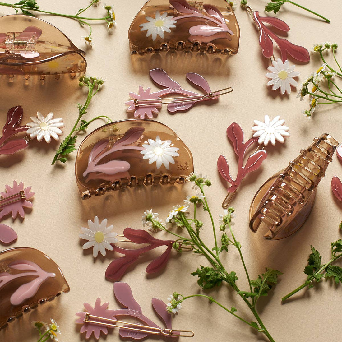 Marguerite Daisy Barrette Set: translucent brown hair claws with white daisies, pink cellulose acetate snap clips, flat lay.