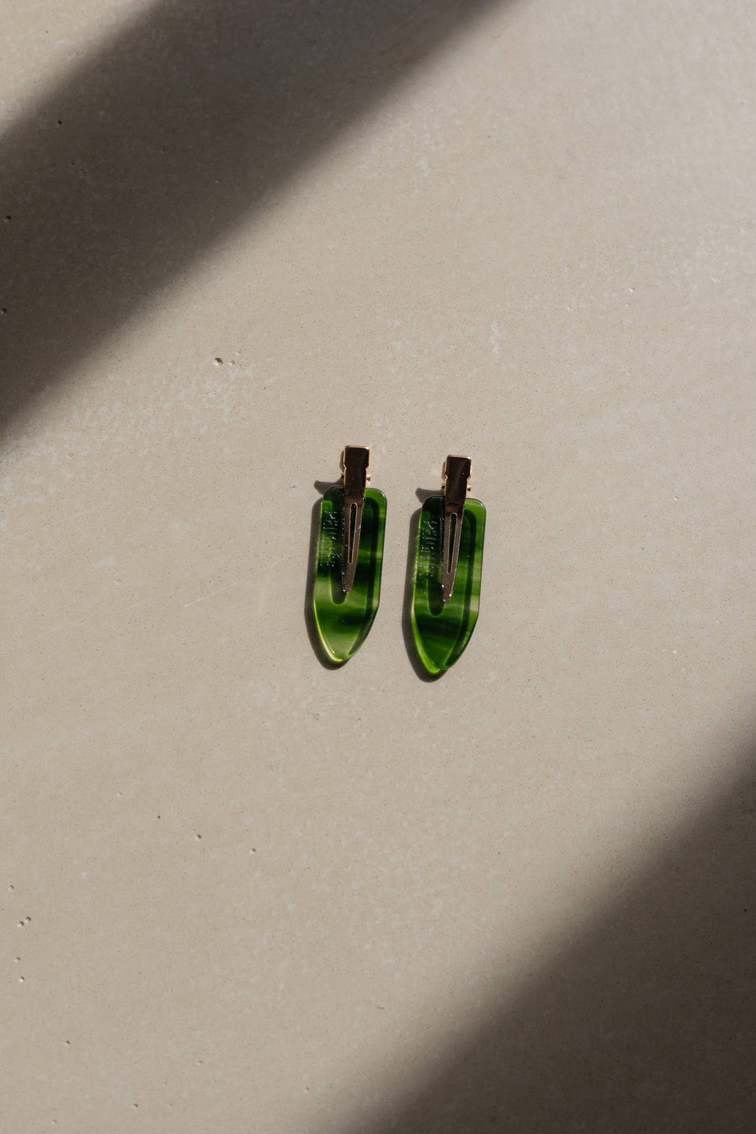 Emerald Hair Clips, set of two, green striped cellulose acetate, flat lay with back view of metal clasps.