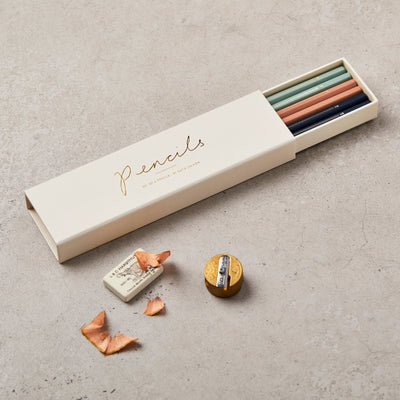 
                    
                      Assorted Pencils set of six in open cream box, showing teal, peach, and navy pencils, white eraser, and brass sharpener with…
                    
                  