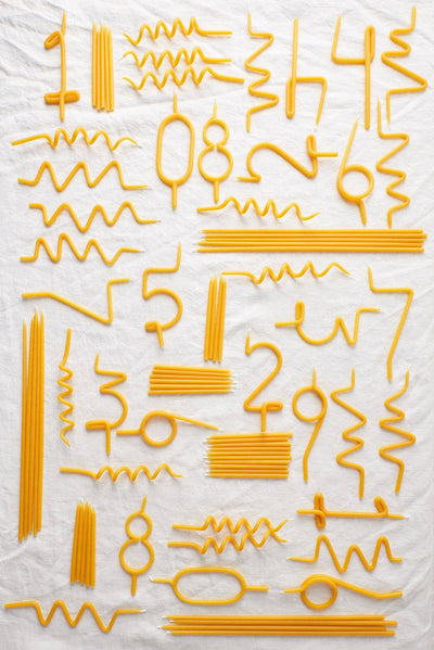 
                    
                      Traditional Birthday Candles, pure yellow beeswax, flat lay showcasing a large assortment of straight, wavy, and…
                    
                  