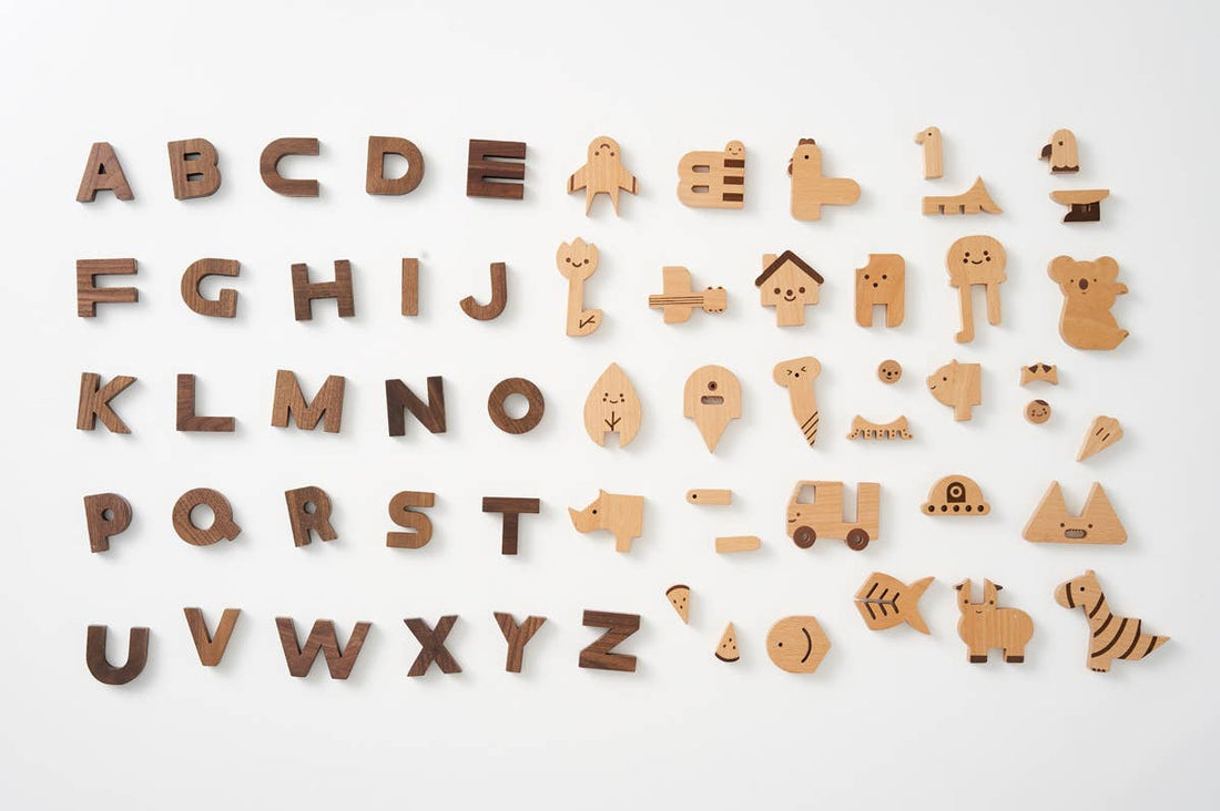 Wooden alphabet letters and symbols on a white background