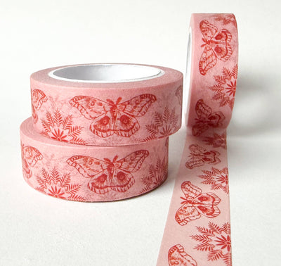 
                    
                      Moths On Pink washi tape, pink rice paper with red moths and ferns, two stacked rolls and one partially unrolled.
                    
                  