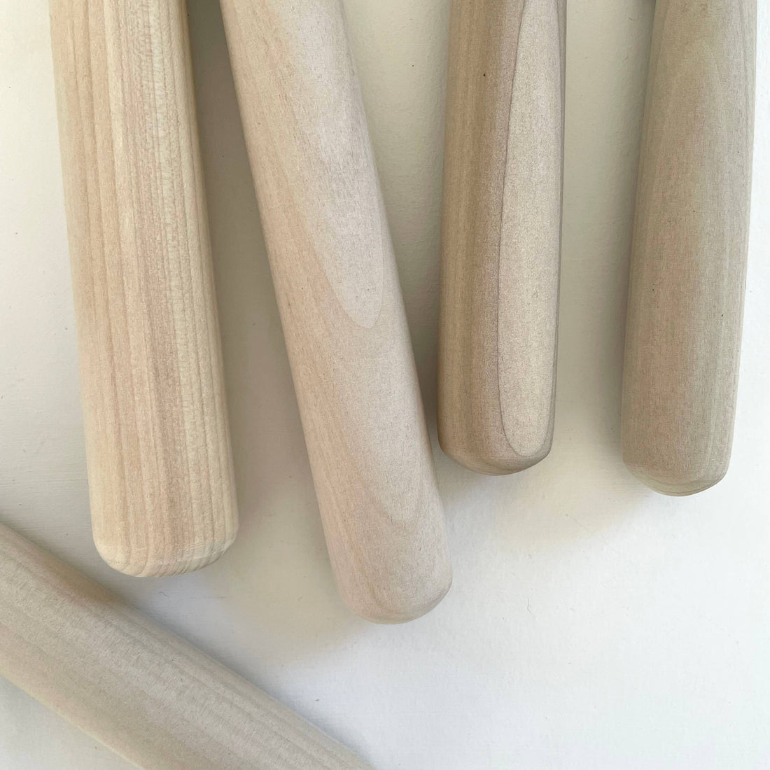 Hinoki Cypress Surikogi pestles, close-up of light wood grain texture and rounded ends
