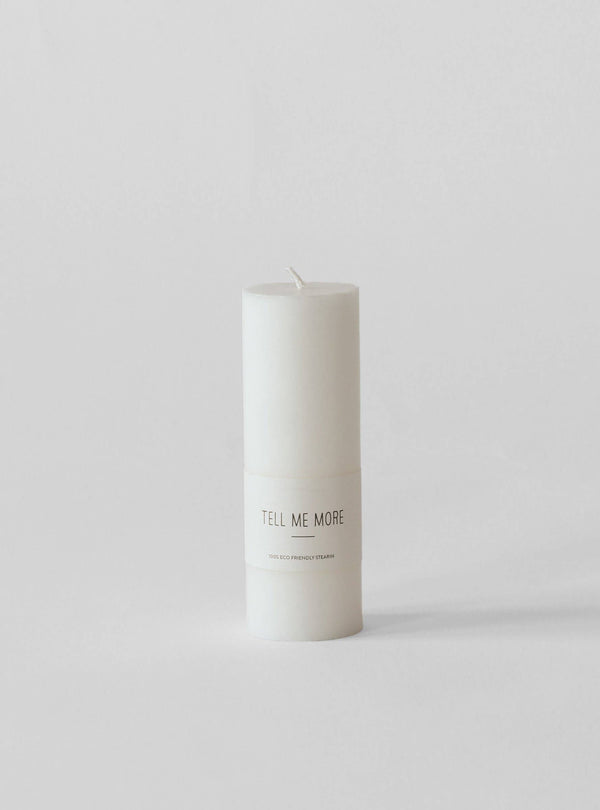 Tell Me More White Pillar Candle, pure stearin, with visible brand label, front view on white.
