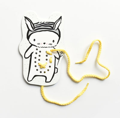 
                    
                      Wee Gallery Baby Animals lacing card, FSC-certified paper rabbit shape, black outlines, partially threaded with yellow…
                    
                  