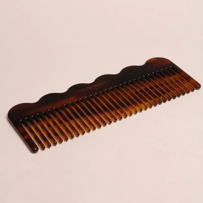 
                    
                      Signature Wide-Tooth Wave Comb, tortoise cellulose acetate, angled flat lay highlighting wide teeth and wavy top edge.
                    
                  