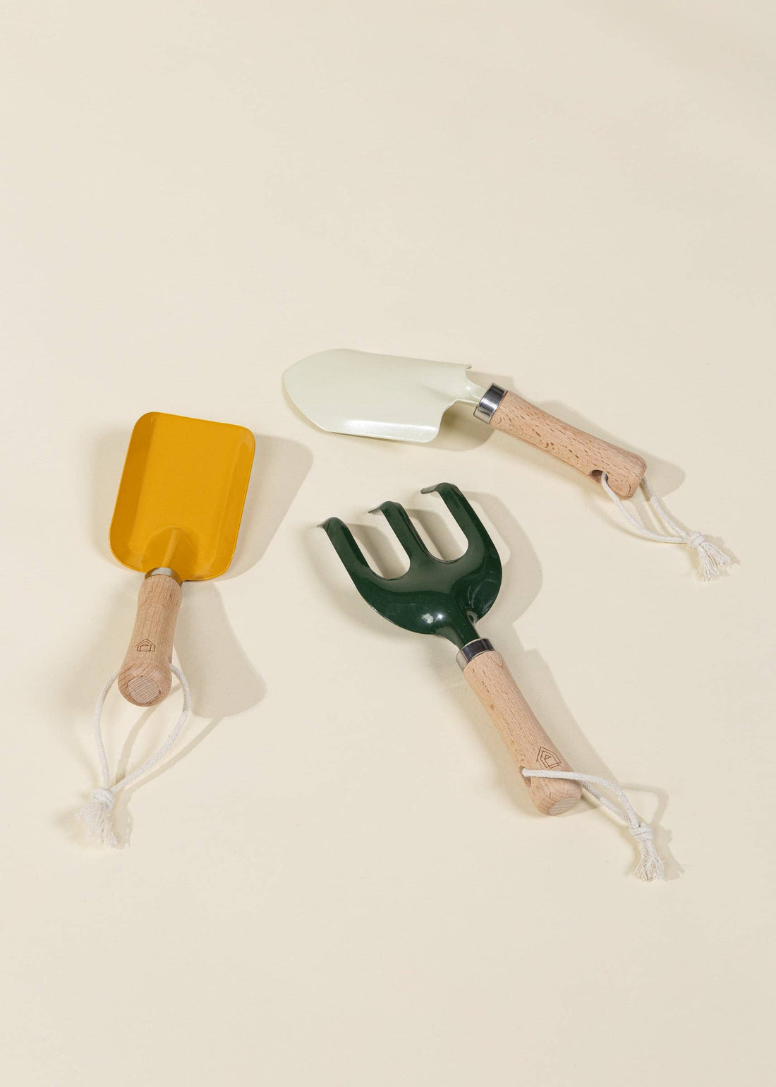 Coco Village Gardening Playset toys: yellow spade, cream trowel, dark green cultivator with natural wood handles, white…