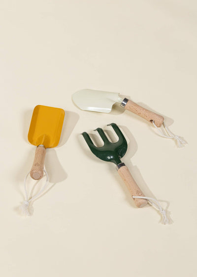 
                    
                      Coco Village Gardening Playset toys: yellow spade, cream trowel, dark green cultivator with natural wood handles, white…
                    
                  