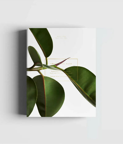 
                    
                      Cozy Publishing Green Home Book, white cover with large green plant leaves and gold text frame, front angled view.
                    
                  