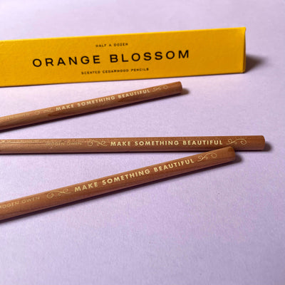 
                    
                      Imogen Owen Orange Blossom Scented Pencils, detail of cedarwood barrels with gold 'Make Something Beautiful' imprint, yellow…
                    
                  