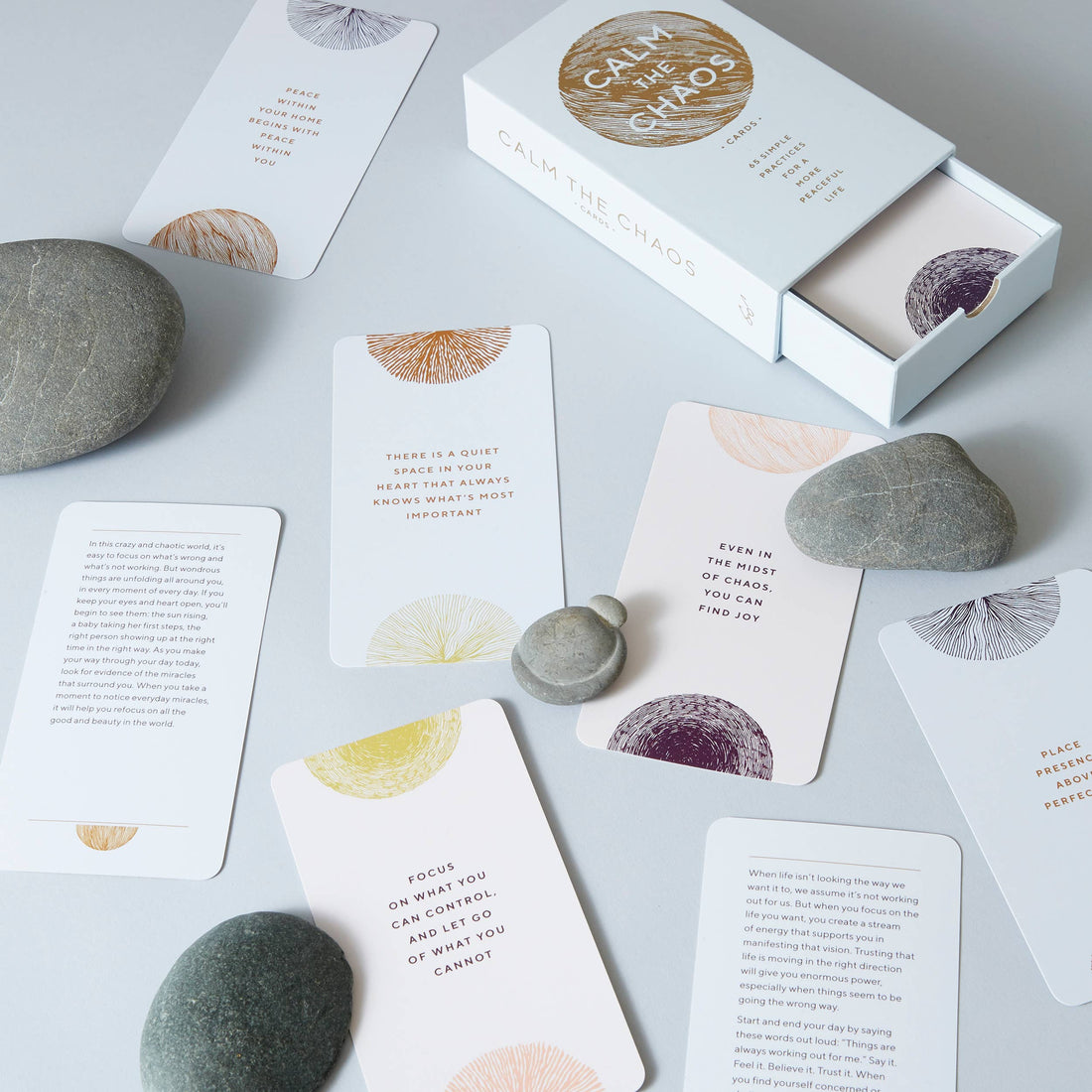 Calm The Chaos Cards mindfulness card deck, flat lay, box open with cards spread out, showing colorful patterns and text on…