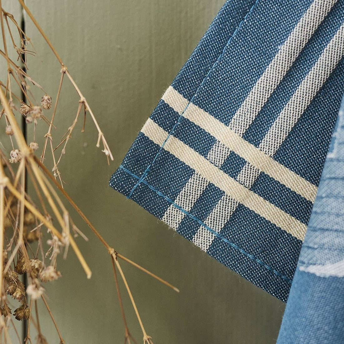 Sylvie Thiriez Torchon Jacquard Coeur Vallée tea towel, close-up of blue cotton weave with beige striped pattern and…