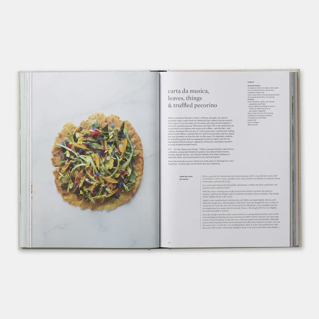 On Vegetables cookbook open to 'carta da musica' recipe, crisp bread with vegetables and flowers.