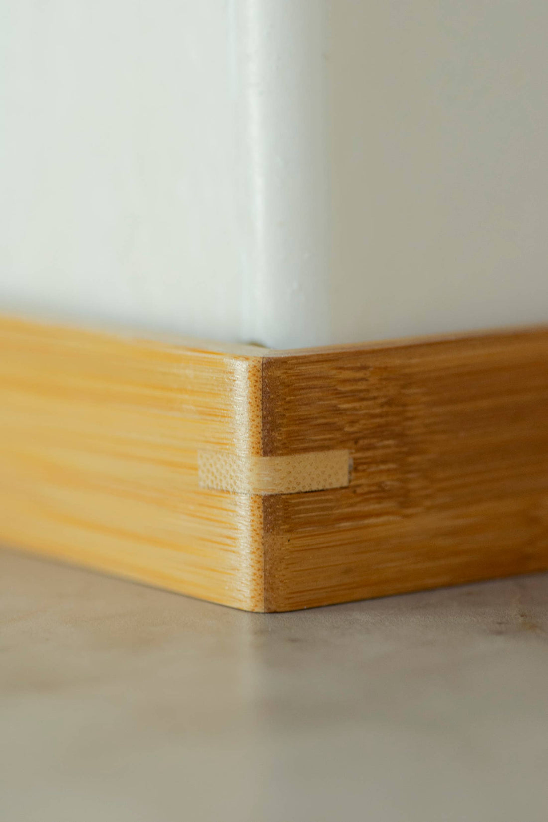 Moso Bamboo Soap Shelf, light brown bamboo, close-up of interlocking corner joint.