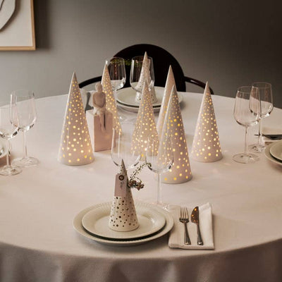 
                    
                      Nobili Ceramic Cone tealight candle holders, bone china ceramic with perforated dots, illuminating a dinner table setting.
                    
                  