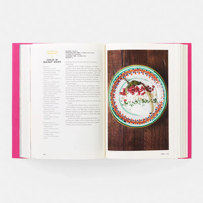 
                    
                      Phaidon Mexico: The Cookbook open spread, colorful Chiles en Nogada food photo and recipe text with pink book edges.
                    
                  
