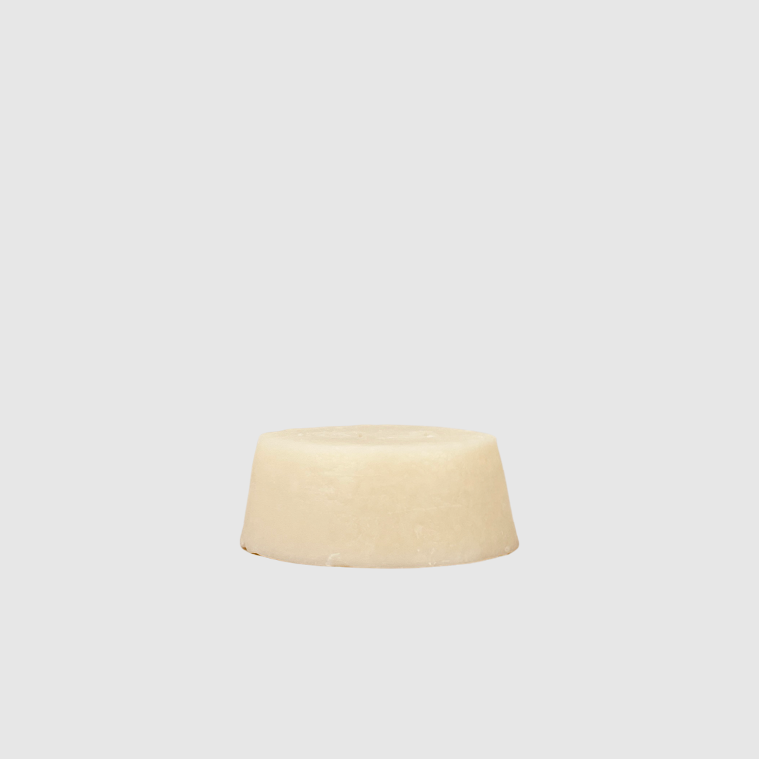 Hair Conditioning Bar with Argan Oil, off-white, angled close-up view showing the top and side of the solid bar.
