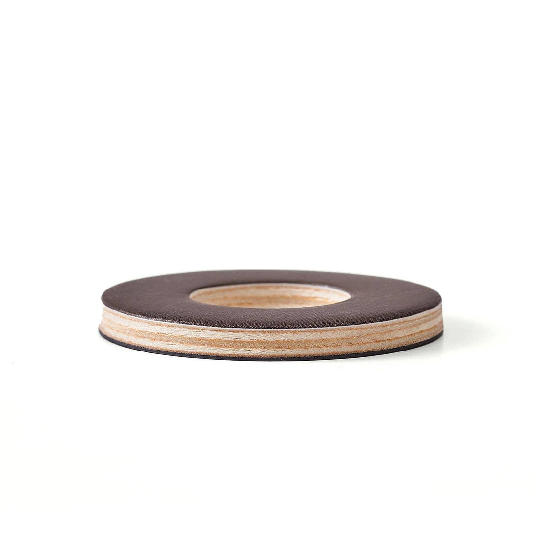 Oioiooi Magnetic Alphabet Play Set disc, dark brown composite top with visible layered wood, angled side view