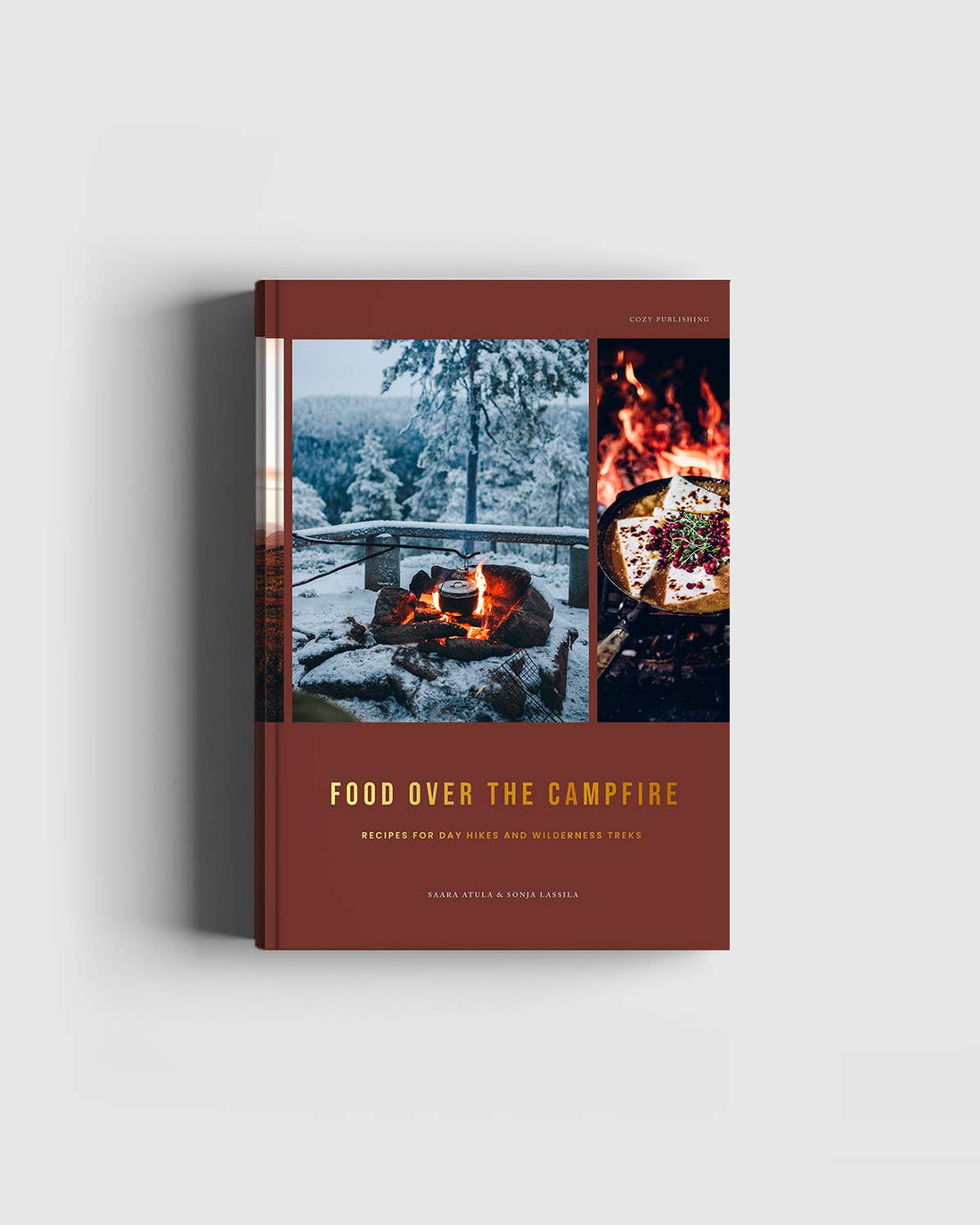 Cozy Publishing Food Over the Campfire print book, reddish-brown cover, art of campfire in snow and food in pan, front on…