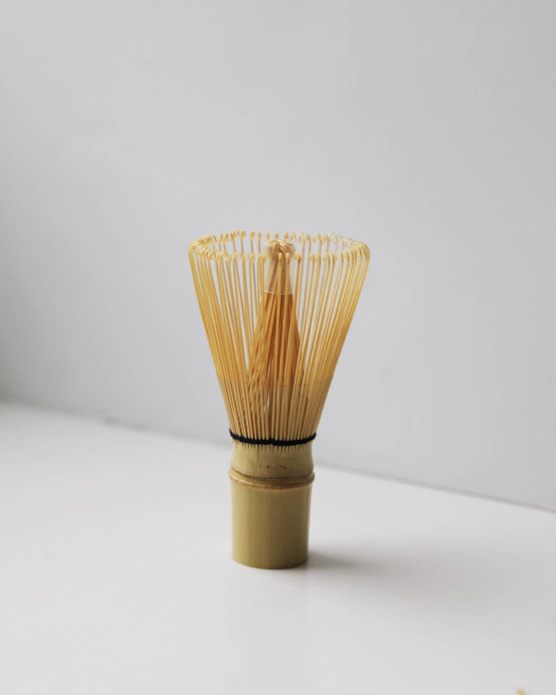 Japanese Style Chasen bamboo tea whisk, natural bamboo color with black string detail, full front view highlighting fine…