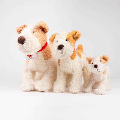 
                    
                      Plush Eliot Stuffed Dog trio, white and brown polyester plush, different sizes grouped together for scale, front view.
                    
                  