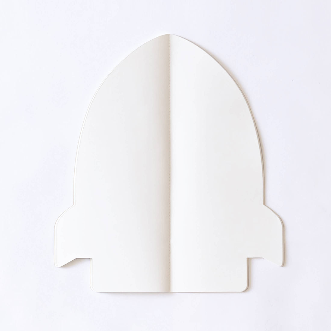 Jumbo Rocket coloring book, off-white recyclable paper, closed flat lay showing saddle stitch binding.