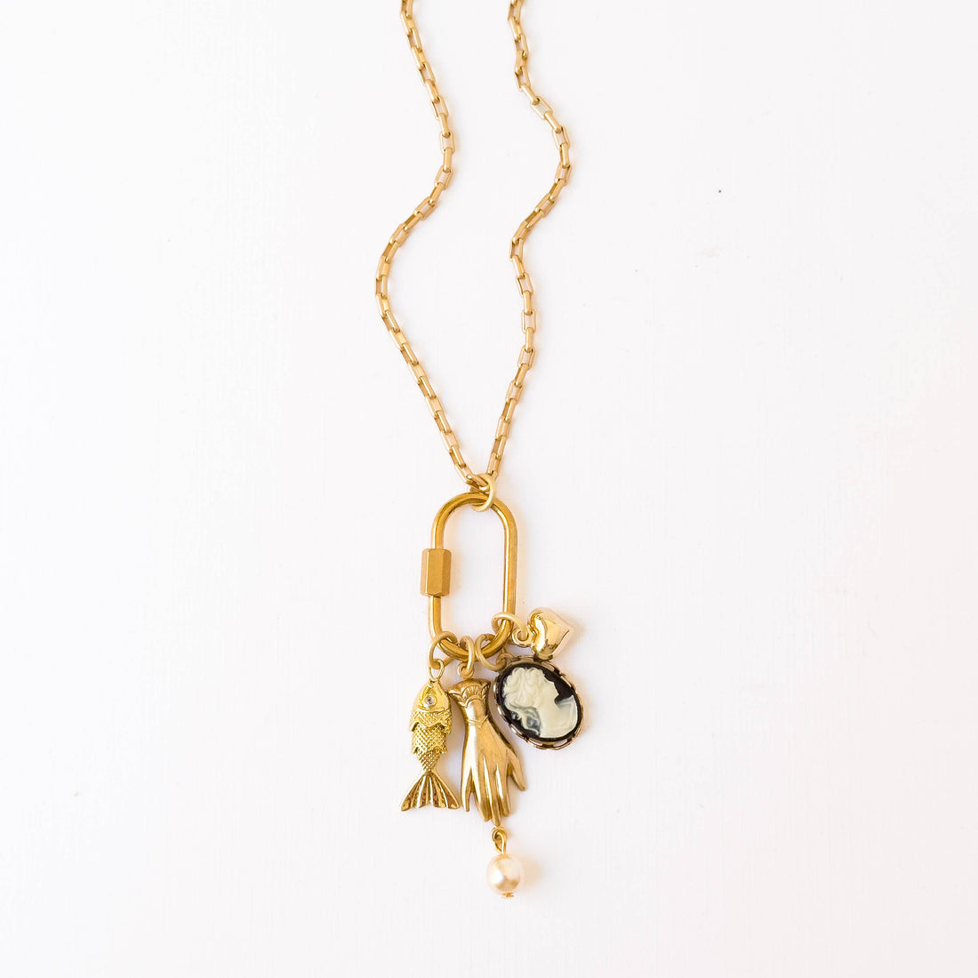 Gold Carabiner Charm Necklace: gold-plated chain & carabiner with clustered fish, hand, black & white cameo, and pearl…