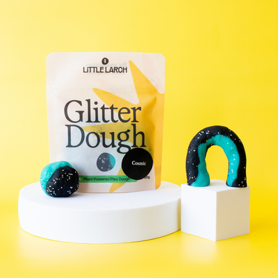 
                    
                      Little Larch Cosmic Glitter Dough packaging with two pieces of dough on a yellow background
                    
                  