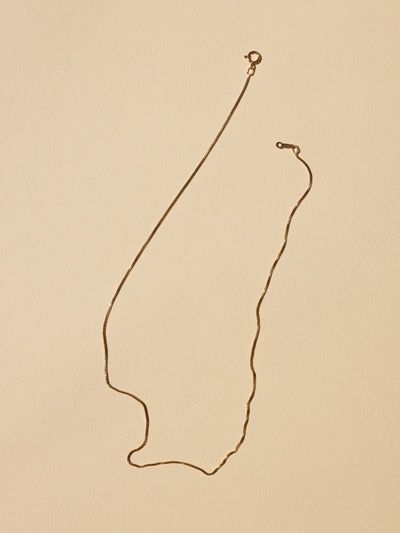 
                    
                      Delicate Gold Box Chain necklace, 18K gold-filled, flat lay detail of lobster clasp and chain links.
                    
                  
