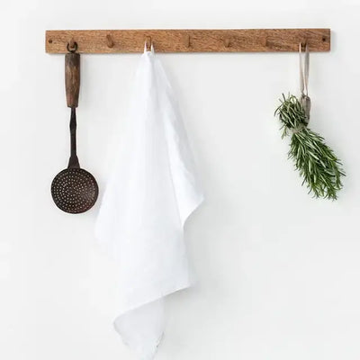 
                    
                      White Premium Linen Tea Towel, 100% linen, hanging on a wooden hook rack, displaying its natural drape.
                    
                  