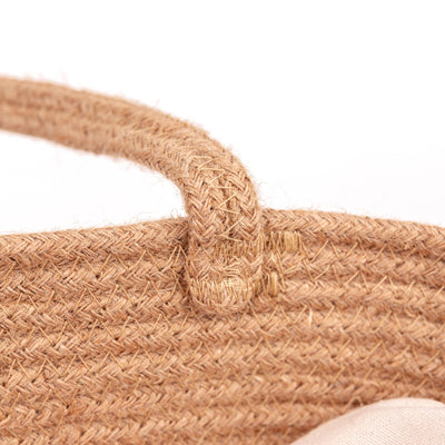 
                    
                      Rope Carrycot close-up, showing intricate braided natural hemp rope texture, handle attachment point, and cotton interior.
                    
                  