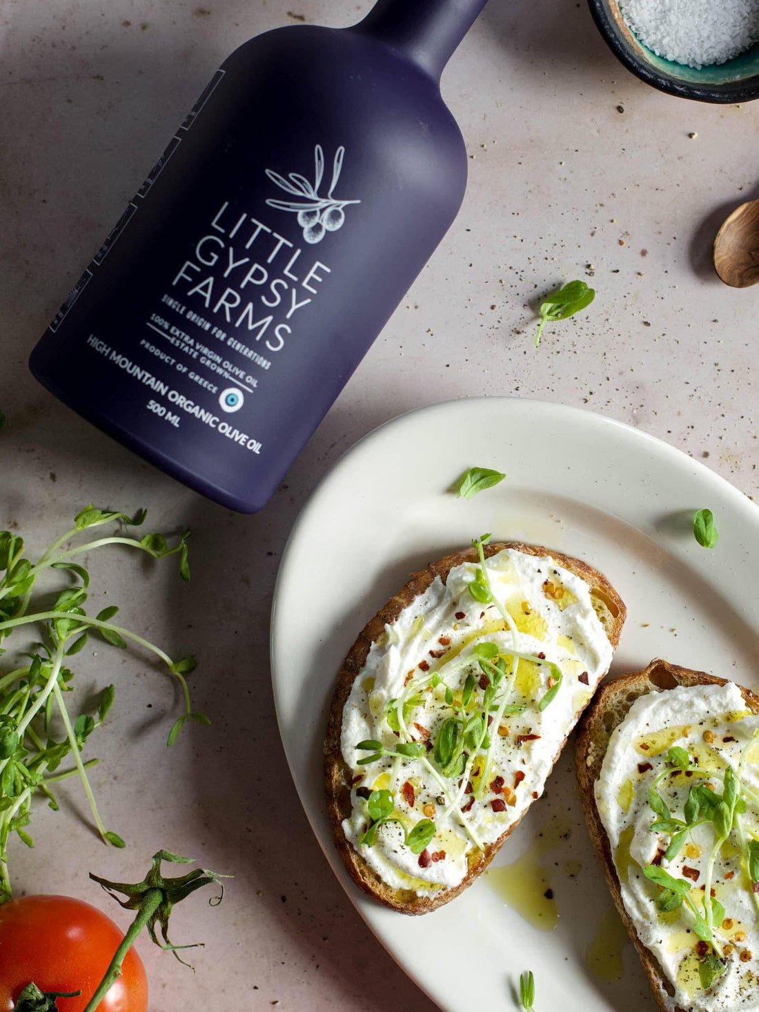 Little Gypsy Farms High Mountain Organic Olive Oil bottle, drizzled onto bruschetta with ricotta and sprouts.