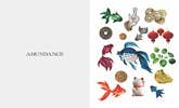
                    
                      Make a Vision Board book, inside spread showing 'ABUNDANCE' on left page and colorful illustrations of fish and coins.
                    
                  