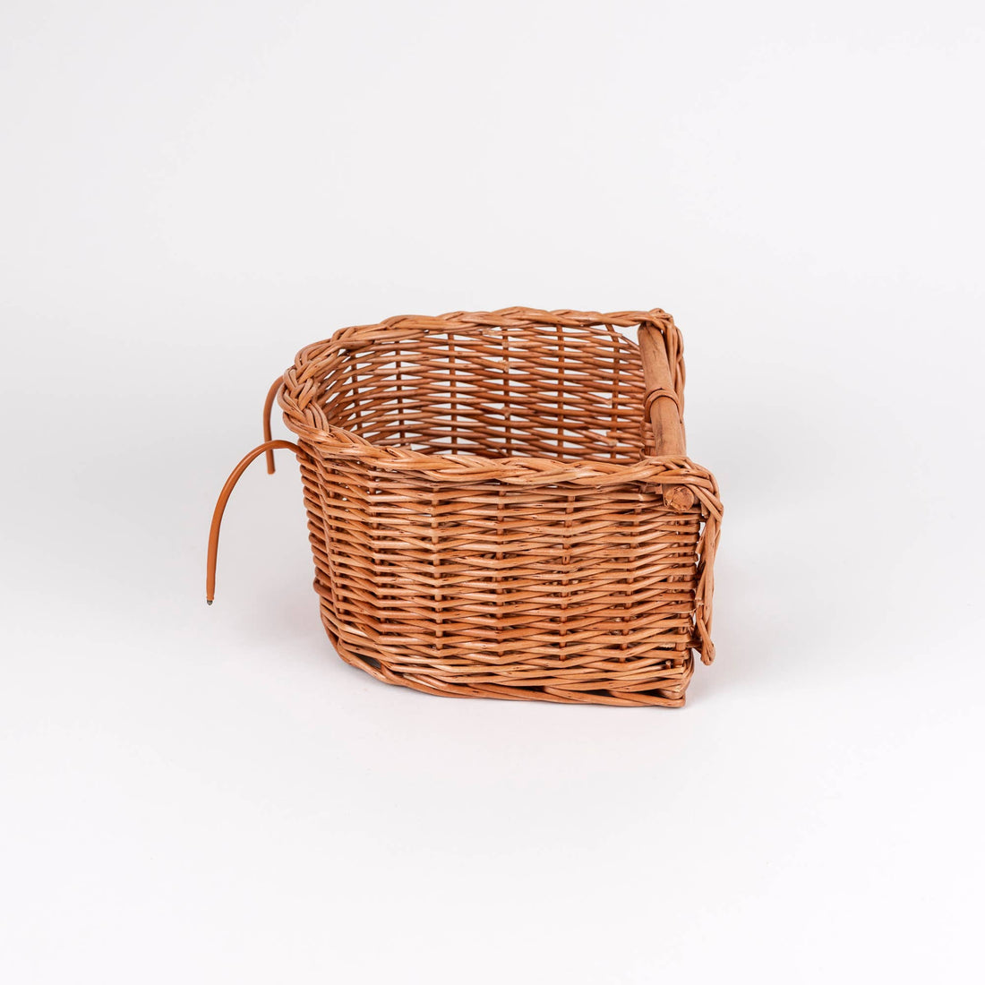 Wicker Bike Seat for Dolls, natural brown woven wicker texture, angled side view highlighting the fastening straps.