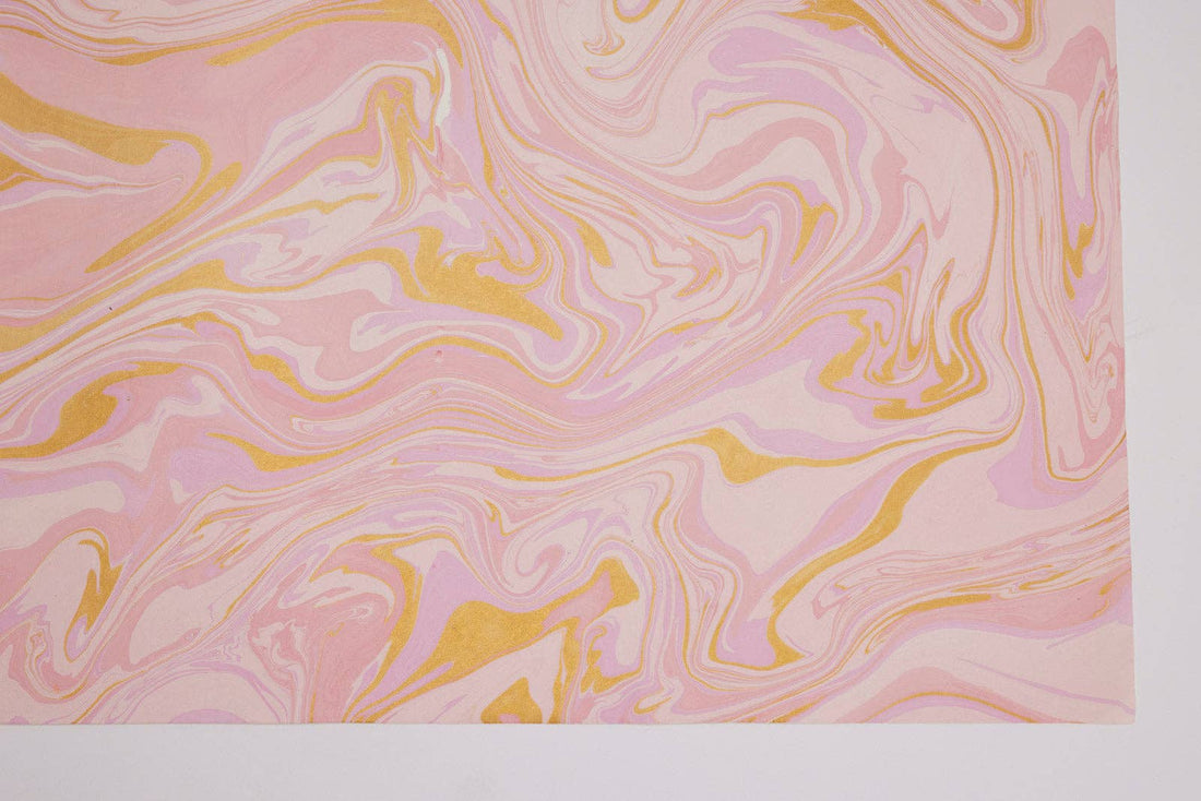 Free Spirit Marshmallow hand marbled wrapping paper, detailed close-up of pink and gold swirling pattern on handmade…