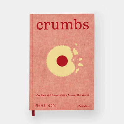 
                    
                      Phaidon Crumbs cookbook, textured reddish-orange hardcover with a partially eaten yellow cookie illustration, front view on…
                    
                  