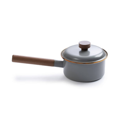 
                    
                      Barebones Enamel Saucepan with Walnut Handle, gray enamel with gold trim, angled view on white background.
                    
                  