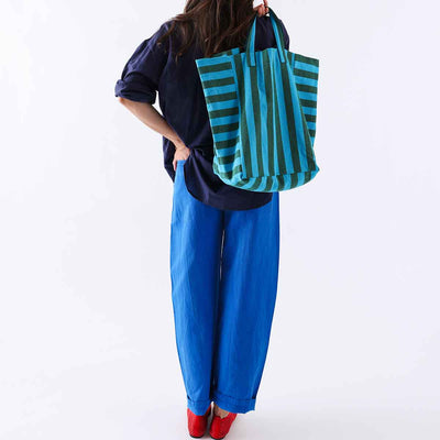 
                    
                      Elisabeth Tote bag, turquoise and olive striped cotton, worn over shoulder on person from behind for scale.
                    
                  