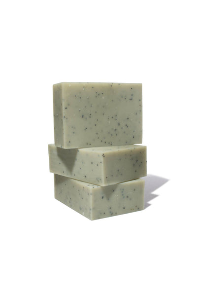 
                    
                      Basil Bar Soap, three light green bars with dark poppy seeds, stacked vertically on white, angled view
                    
                  